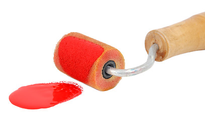Image showing Closeup of roller applying bright red paint