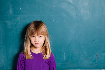 Image showing Young girl in front of chalkboard