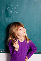 Image showing Young girl and chalkboard with letters