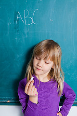 Image showing Young girl and chalkboard with letters