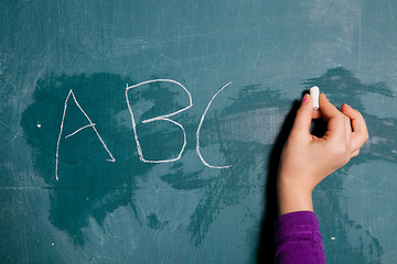 Image showing Wiriting letters on chalkboard