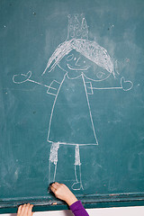 Image showing Child drawing picture on chalkboard