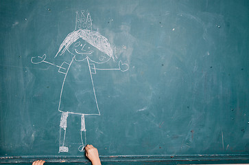 Image showing Child drawing picture on chalkboard