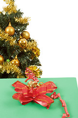 Image showing yellow decorated christmas tree  and gift with red ribbon