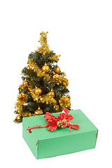 Image showing yellow decorated christmas tree  and gift with red ribbon