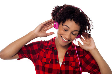 Image showing Casual woman lost in pleasant musical world
