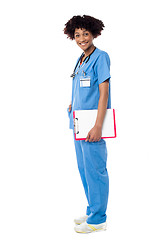 Image showing Medical expert posing sideways, holding clipboard