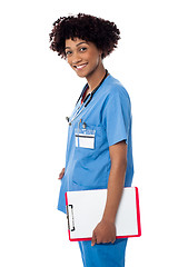 Image showing Smiling medical professional holding blank clipboard