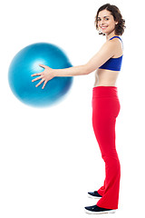 Image showing Fit woman posing with big blue exercising ball