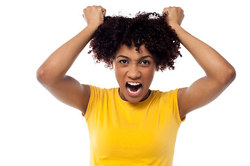 Image showing Angry young woman pulling her hair out