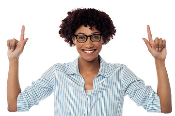 Image showing Excited woman pointing upwards