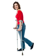 Image showing Woman walking with the help of crutches