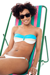 Image showing Sexy bikini model seated on a deckchair