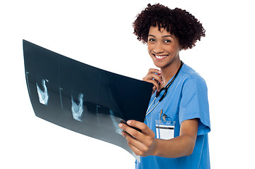 Image showing Attractive young medical professional holding x-ray sheet