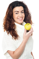 Image showing Joyous woman with an apple in hand