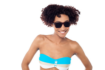 Image showing Smiling curly haired bikini model in dark shades