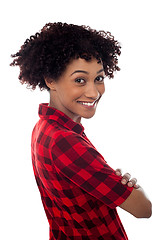 Image showing Side profile of slim young smiling woman, arms crossed