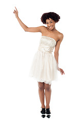 Image showing Joyous fashion female model pointing upwards