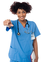 Image showing Smiling lady doctor pointing you out