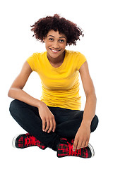 Image showing Smiling lady sitting legs crossed on the floor