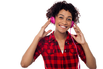 Image showing Smiling woman with pink headphones on