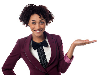 Image showing Smiling woman presenting copy space area