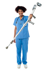 Image showing Lady doctor handing over crutches to the patient