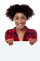 Image showing Charming woman holding blank whiteboard