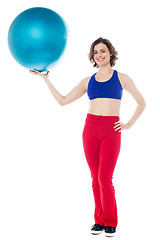 Image showing Lady gym instructor holding pilates ball