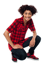 Image showing Smiling female model in squatting posture