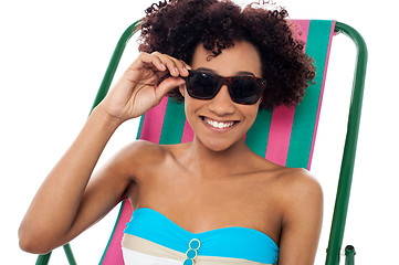 Image showing Relaxing female model adjusting her shades