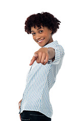 Image showing Curly haired casual woman pointing towards you