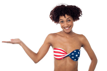 Image showing Smiling model in stars and stripes bikini presenting copy space