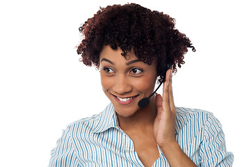 Image showing Casual shot of a call centre executive looking away