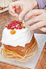 Image showing Hands decorating christmas cake