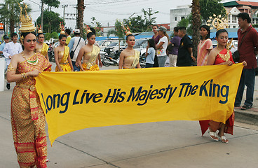 Image showing Thai women in traditional dress carry a banner to pay respect to