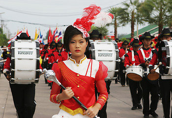 Image showing Beautiful young Thai girl leads a marching band during a parade,