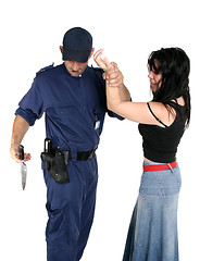 Image showing Officer disarms a weapon from a suspected criminal