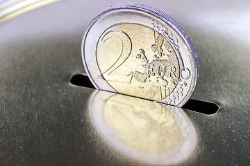 Image showing saving two euros in a piggy bank