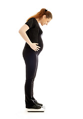 Image showing pregnant lady weighing oneself