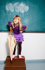 Image showing Smiling young girl with umbrella indoors