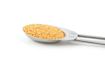 Image showing Garlic granules measured in a metal teaspoon
