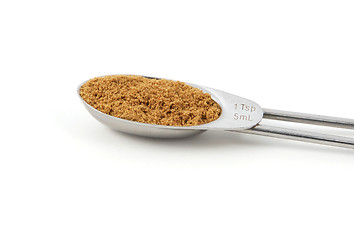 Image showing Ground coriander measured in a metal teaspoon
