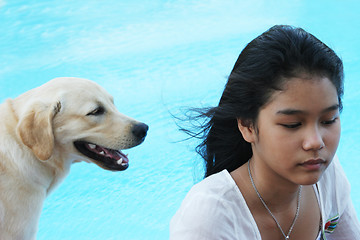 Image showing Asian girl with her pet dog (focus is on the girl).