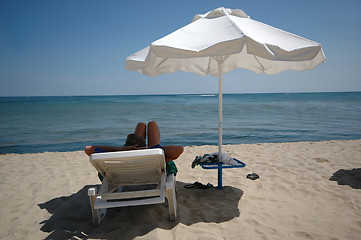 Image showing Man, umbrella and sunbed