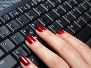 Image showing Woman typing on a keyboard