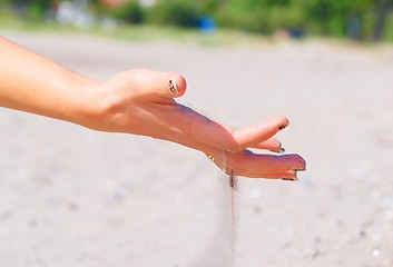 Image showing Sand through hand