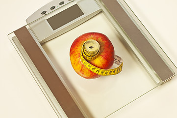 Image showing bathroom scales with measure and apple