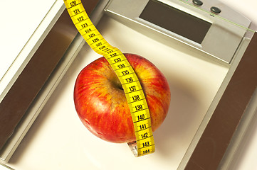 Image showing bathroom scales with measure and apple