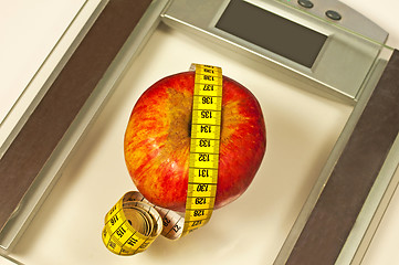 Image showing bathroom scales with measure and apple